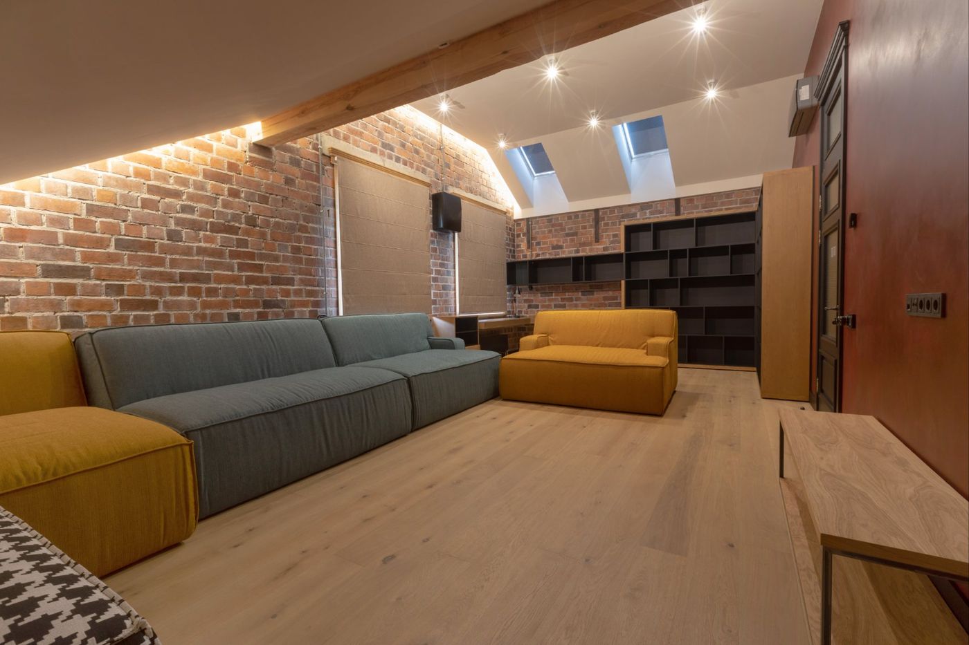 Attic living space with exposed brick and skylights, Glen Cove NY