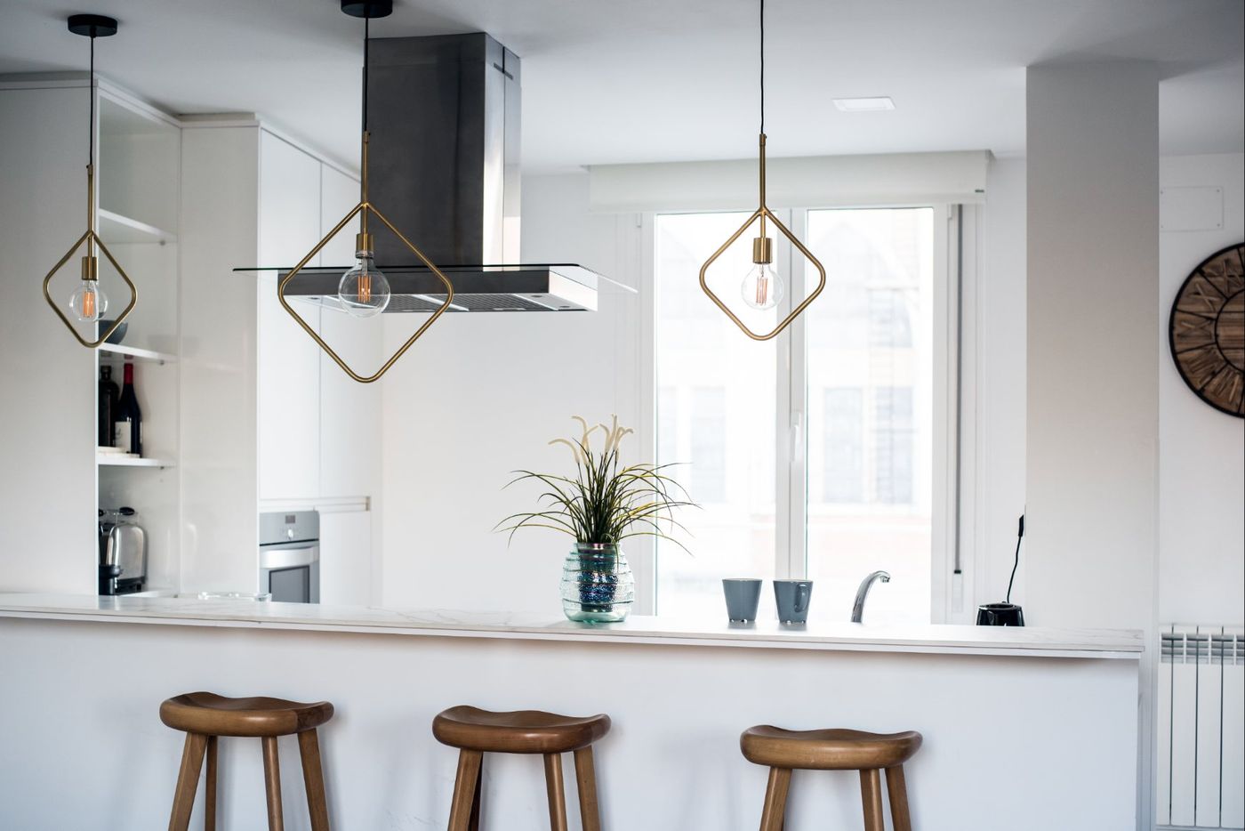 Modern white kitchen with pendant lights and island seating